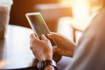 Woman holding mobile phone on blur background