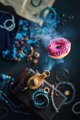 Genie lamp with a pink donut as a fulfilled wish, sweet tooth concept, magical food photo