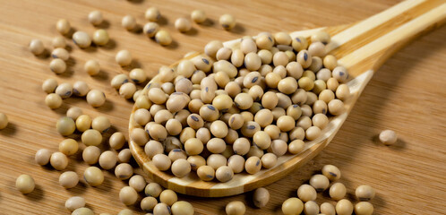Soybeans in a wooden spoon on the table