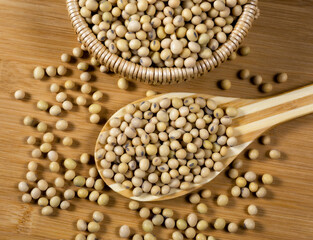 Soybeans in a wooden spoon on the table