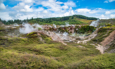 Fototapeta na wymiar The scenery view of steaming vents in the lunar landscape of Crater of the moon in Taupo, New Zealand. Craters of the Moon is a geothermal walkway with Lunar Landscapes.