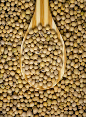 Soybeans in a wooden spoon on the table