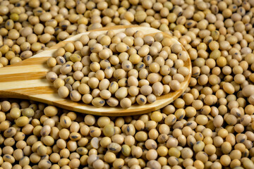 Soybeans in a wooden spoon on the table