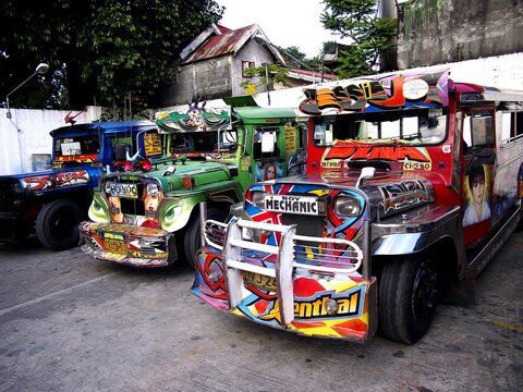 Colorful passenger jeepneys with artistic designs at a jeepney parking lot.