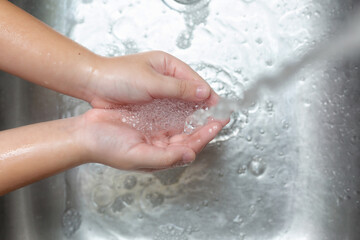 Coronavirus pandemic prevention wash hands with soap warm water and rubbing nails and fingers...