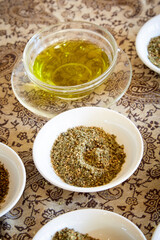 White Bowl of Za'atar Spice Mix and Clear Bowl of Olive Oil