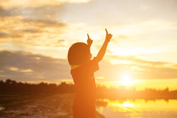 Fototapeta premium kid silhouette,Moments of the child's joy. On the Nature sunset