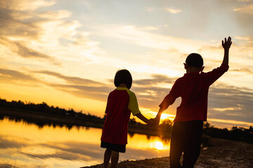 Fototapeta premium kid silhouette,Moments of the child's joy. On the Nature sunset
