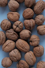 Walnut set close-up on a light blue wooden background.Organic Pure Bio Product. Useful Snack. Healthy fats