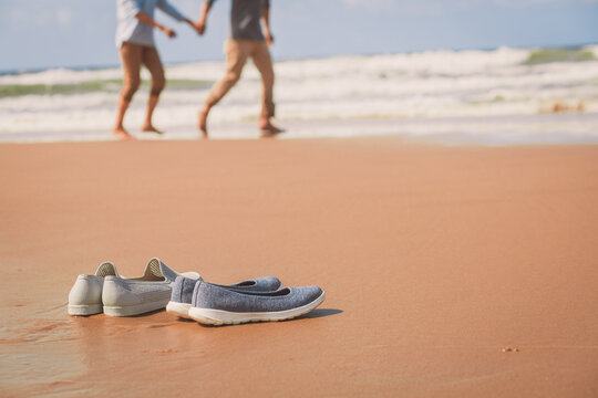 Shoes of elderly senior couple on the Beach on Sand,. Vacation, travel or journey..Retirement age concept and love, copy space for text