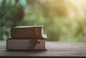 Bible book put on wood desk table old vintage for background.