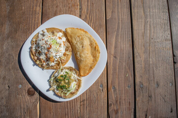 top view variety of mexican food like sope, tacos and quesadilla