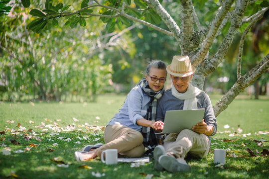 Romantic senior couple. sitting resting and check Social Media communication in the park. Love is everything, image no focus..Retirement age concept and love, copy space for text