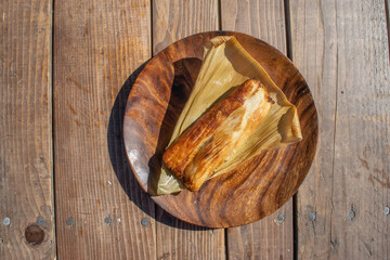 Mexican food dish. fried tamal on wooden table
