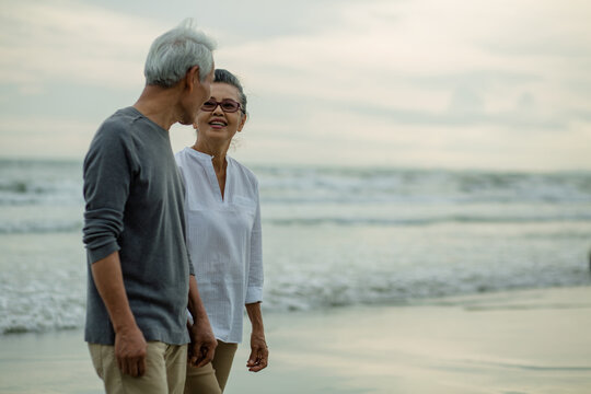 Happy Romantic of senior elderly couple together talking at beach . Love is everything, image no focus..Retirement age concept and love, copy space for text