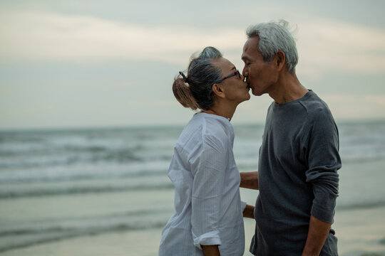 Romantic of senior couple kissing his wife's at beach . Love is everything, image no focus..Retirement age concept and love, copy space for text