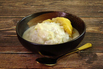 Durian sticky rice in coconut milk and durian creamy sauce. One of most famous Thai dessert in summer of durian season. Selective focus