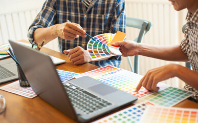 Fototapeta na wymiar Professional designers discuss and select color samples for design work.