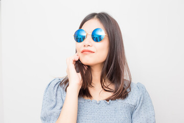 Fashion model asian girl posting with sunglasses isolated over white background