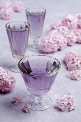 Obraz na płótnie Canvas Transparent lilac drink in glass