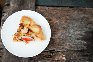 Delicious Italian food Sliced of Pizza on White dish and wooden floor