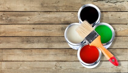 Different colorful paints in the metal can and brush