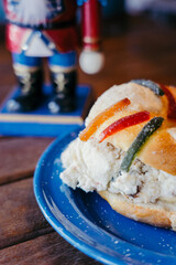 Close up of rosca de reyes with fruits and nutcraker on the dark background