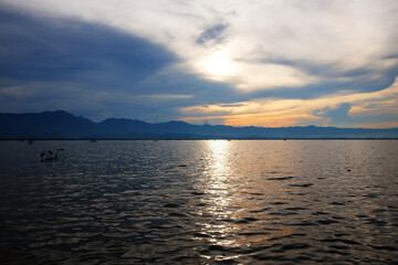 Destination of Beautiful Silhouette and  twilight of sunset Reflected light on the water surface and glittering waves in the River