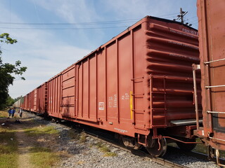 Fototapeta premium A red wagon on the train tracks on Inglaterrra Avenue