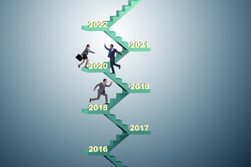 Businessman climbing stairs on yearly basis