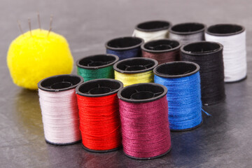 Accessories and tools for using in sewing. Spools of thread and needle