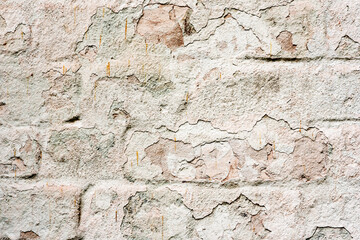 Weathered texture of stained old green and white brick wall background