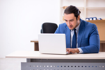 Young male employee in relocation concept