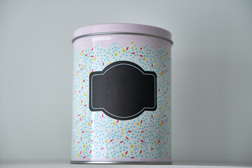 Food can. Container for cereals. Multi-colored container. Black sticker. High quality photo