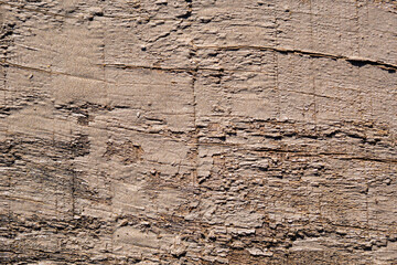 Cracked paint on a painted old wooden surface, table. Beige oil paint drops off the surface of the furniture. Structure of old wood panels