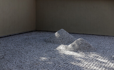 Fototapeta na wymiar two gravel mounds in a Japanese garden
