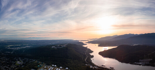 Aerial Panoramic View of a Modern City, Burnaby Mountain and Inlet during a colorful Sunset. Vancouver, British Columbia, Canada. Cityscape Panorama