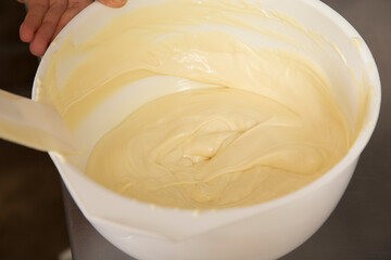 Stirring the melted white chocolate in a bowl.