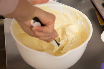 Stirring the melted white chocolate in a bowl.