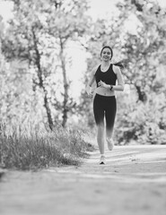 Young beautiful caucasian woman jogging in park.