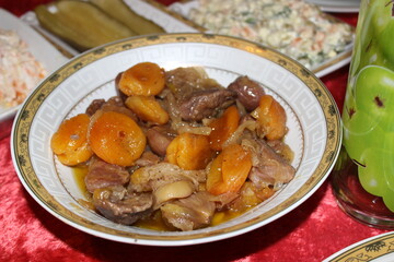 Meat stew, turshu govurma with onions and chestnuts served on plate.