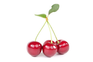 Sweet cherries with green leaf isolated on white background