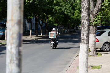 Naklejka premium Fast food delivery on scooters in the city.