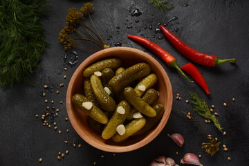 Homemade small  cucumbers, fermented, salted or marinated pickles with garlic, chili and dill