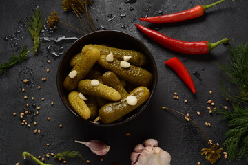 Homemade small  cucumbers, fermented, salted or marinated pickles with garlic, chili and dill