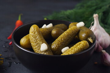 Homemade small  cucumbers, fermented, salted or marinated pickles with garlic, chili and dill