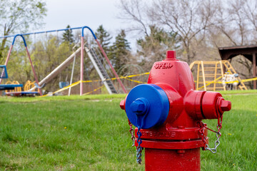 Fire hydrant by park with yellow tape