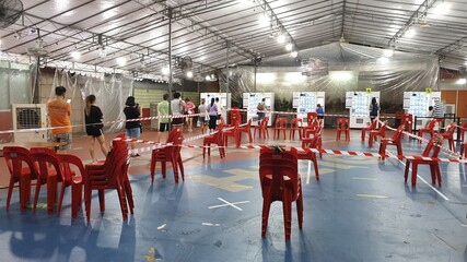 People are queuing up with a safe distance apart to collect the free reusable face mask from vending machine distributed by Government of Singapore during the COVID-19 crisis