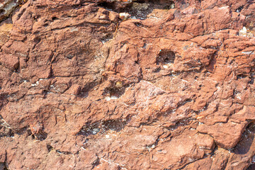 Obraz premium uneven surface of porous brown stone, rough weathered texture, background image, pattern for printing