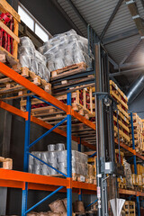 Fork lifter with pallet in warehouse. Forklift loader in storage warehouse ship yard. Distribution products. Delivery Business. Logistics. Hand pallet truck in warehouse moving boxes from shelf